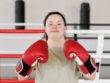 girl woman with down syndrome wearing boxing gloves happy