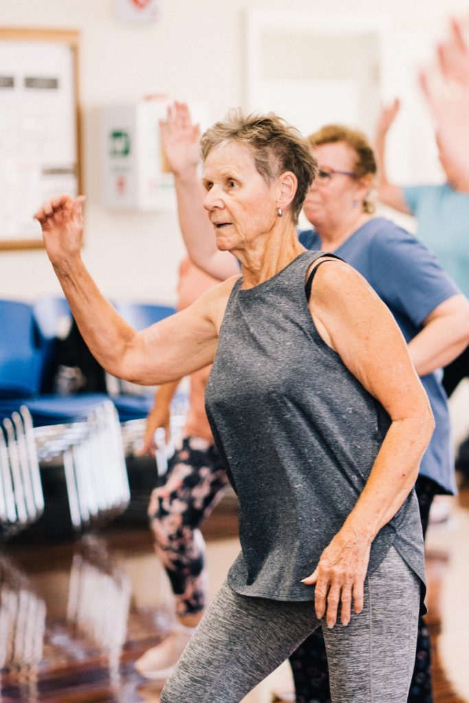 Lady in grey singlet dancing in a dancing class