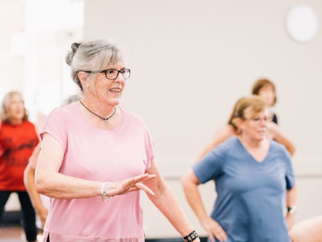 Lady in pink shirt dancing