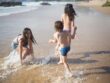 Kids playing in shallow water at beach